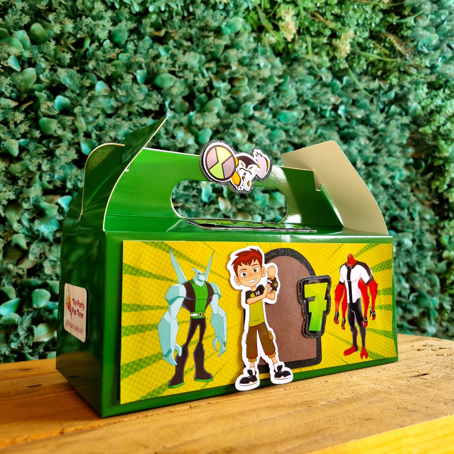 Toy figure of a character from a cartoon on a green box with colorful graphics, placed outdoors.