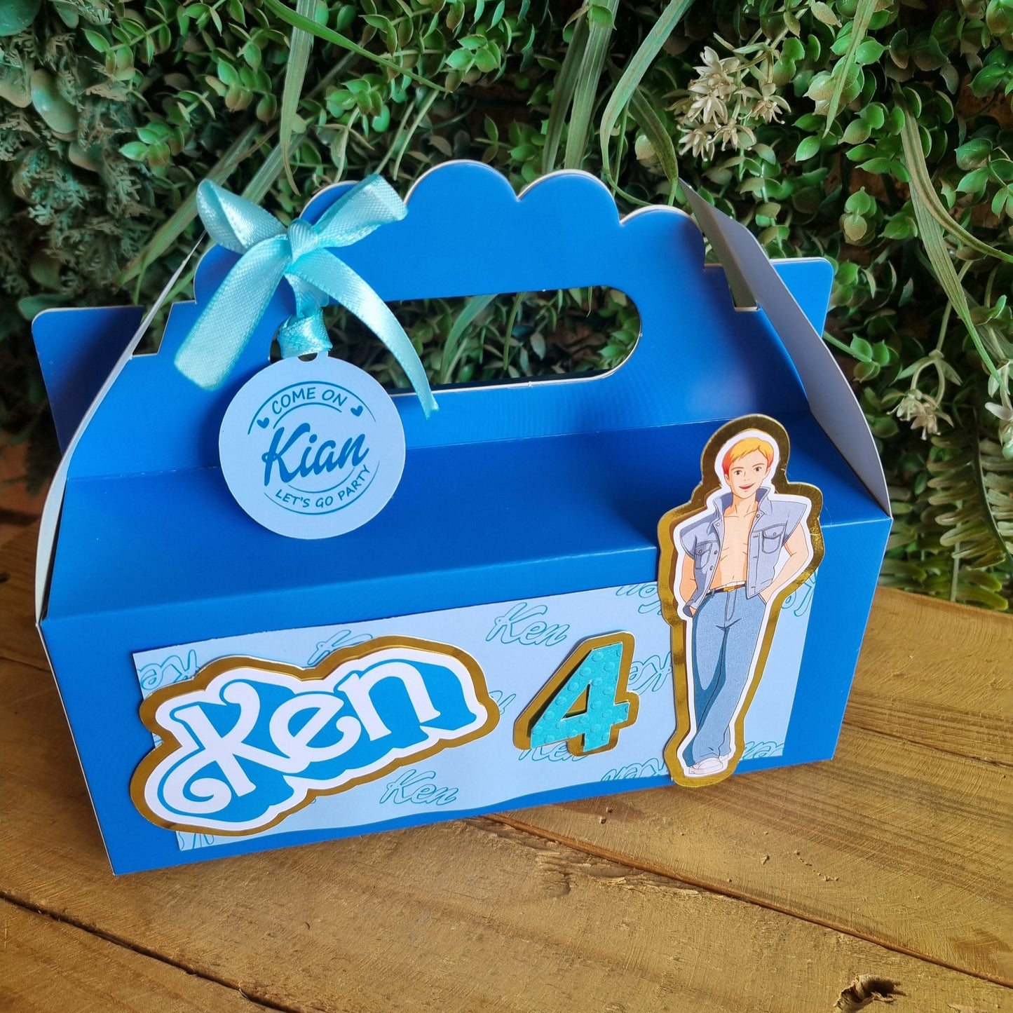 Blue decorative box with a ribbon on a wooden surface