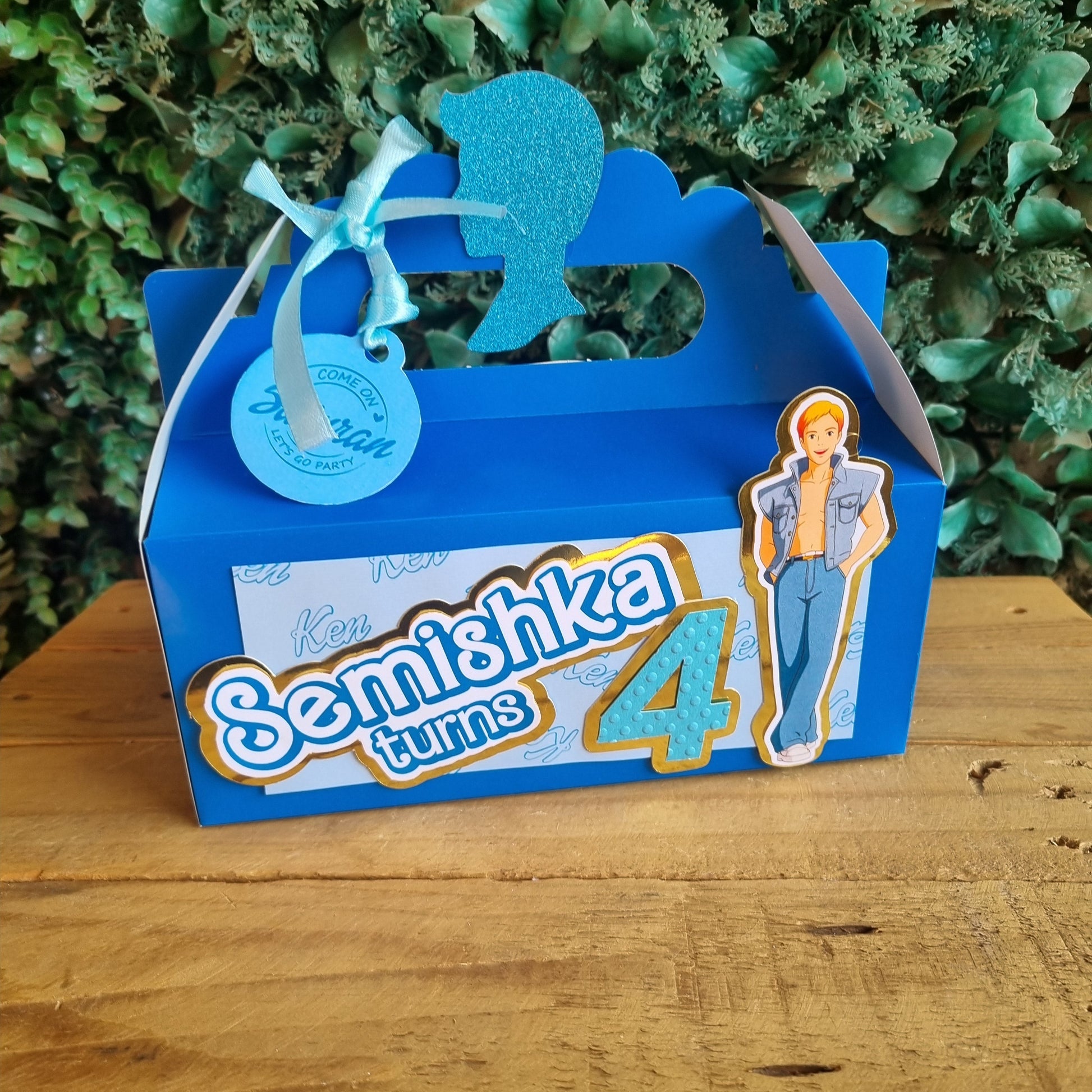 Blue card with 'Beeuthika' branding on a wooden surface and green foliage background