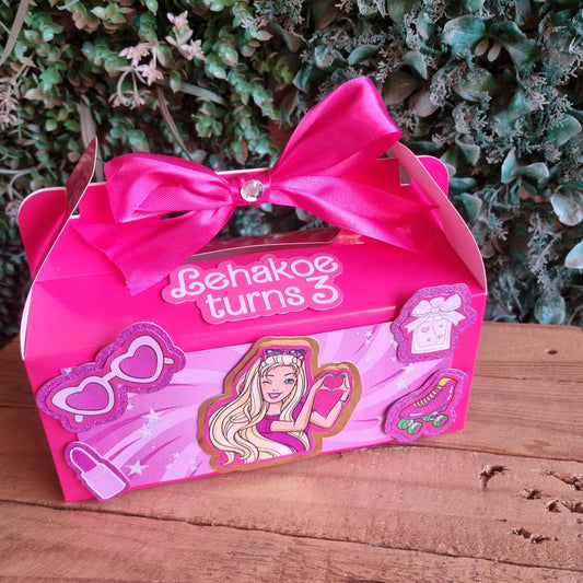 Barbie-themed birthday card with pink ribbon on a wooden surface
