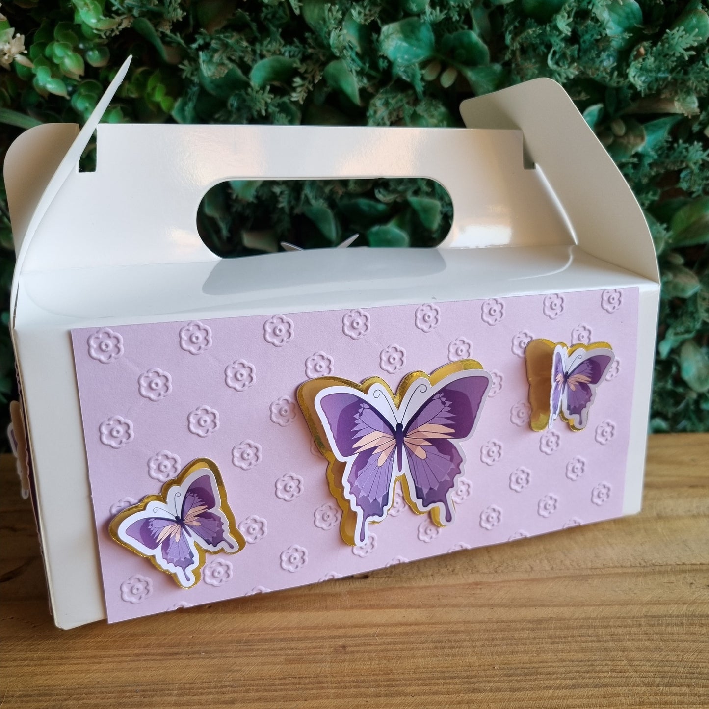 Decorative card with butterfly designs on a wooden surface