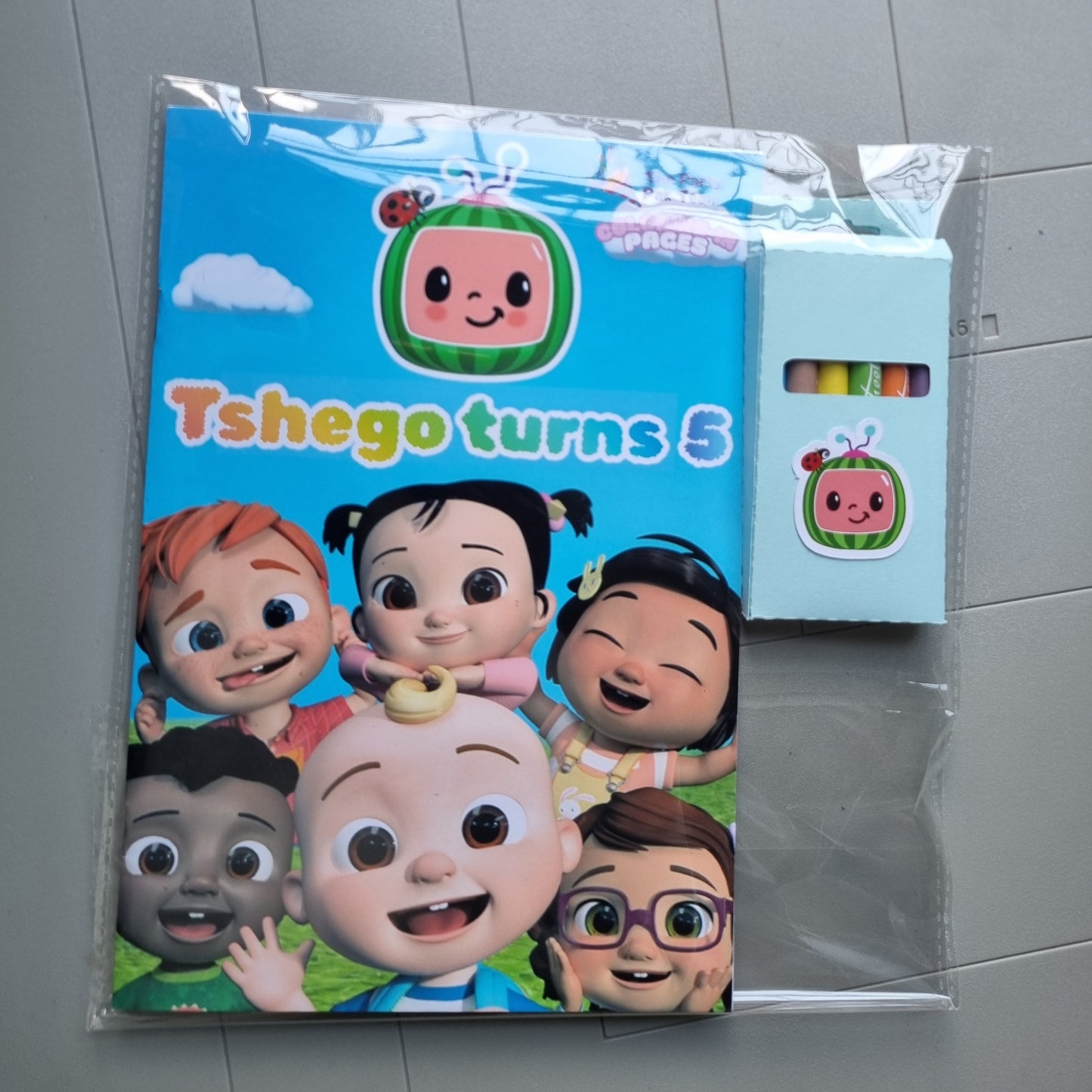 Cartoon-themed product packaging on a tiled floor