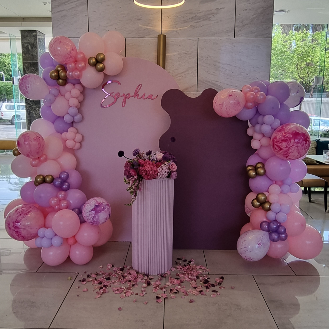PINK AND PURPLE Double Chiara Backdrop with Organic Balloon Garland and Plinth