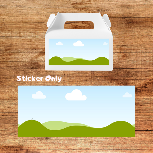 Sticker of a landscape with green hills and blue sky on a wooden surface
