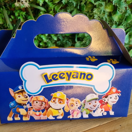 Blue box with cartoon characters on a wooden surface and green plants in the background