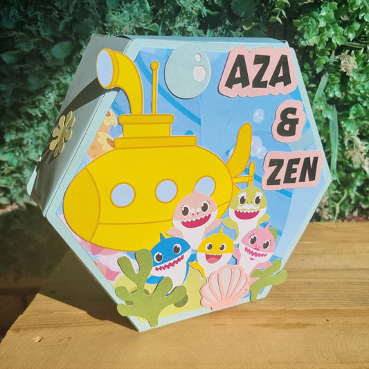 Children's book with a yellow submarine and sea creature illustrations on a hexagonal surface.