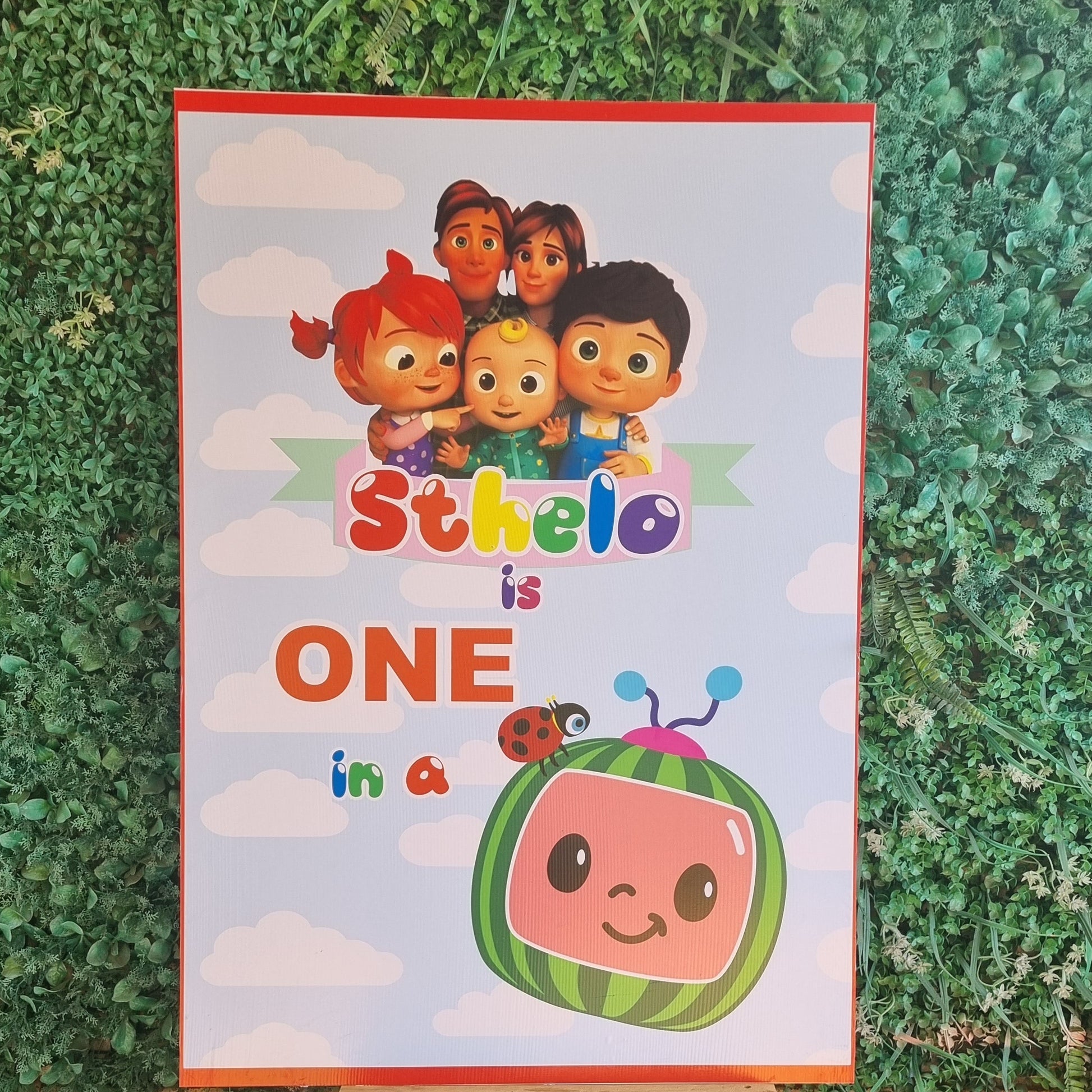 Children's book titled 'Sesame Street' on a grassy surface with a wooden stool.