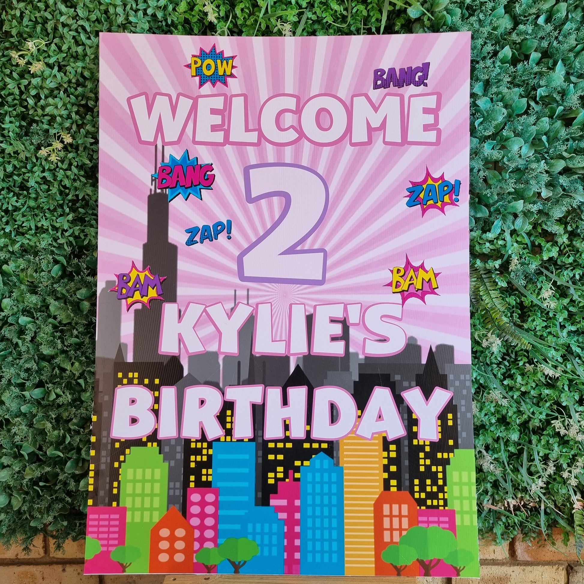 Colorful birthday sign with text on a grassy background