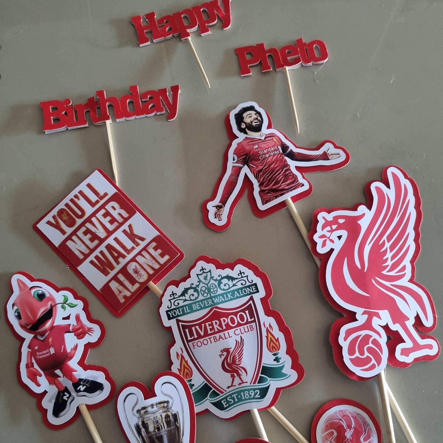 Collection of Liverpool FC-themed cupcake toppers on sticks.