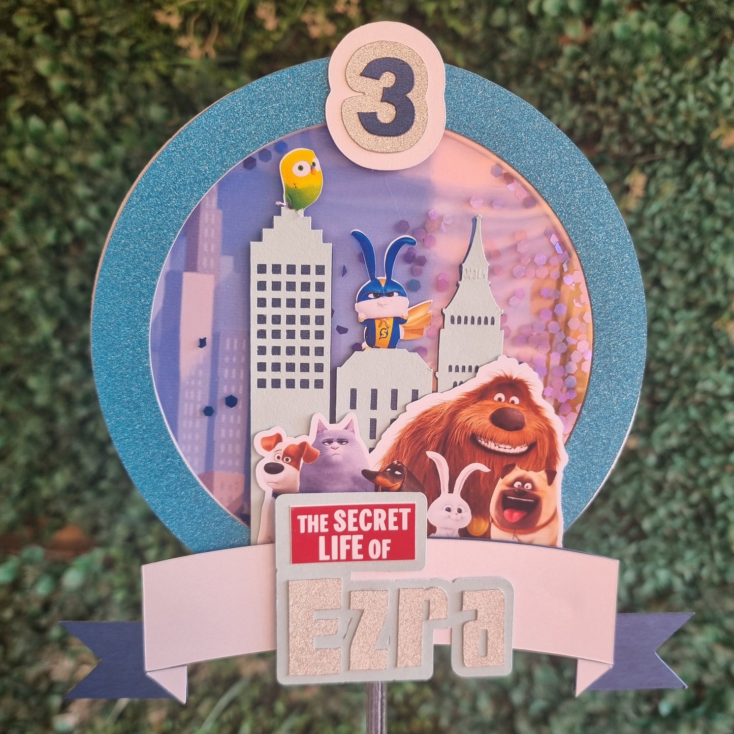 Decorative item with 'The Secret Life of Pets' theme on a textured green background