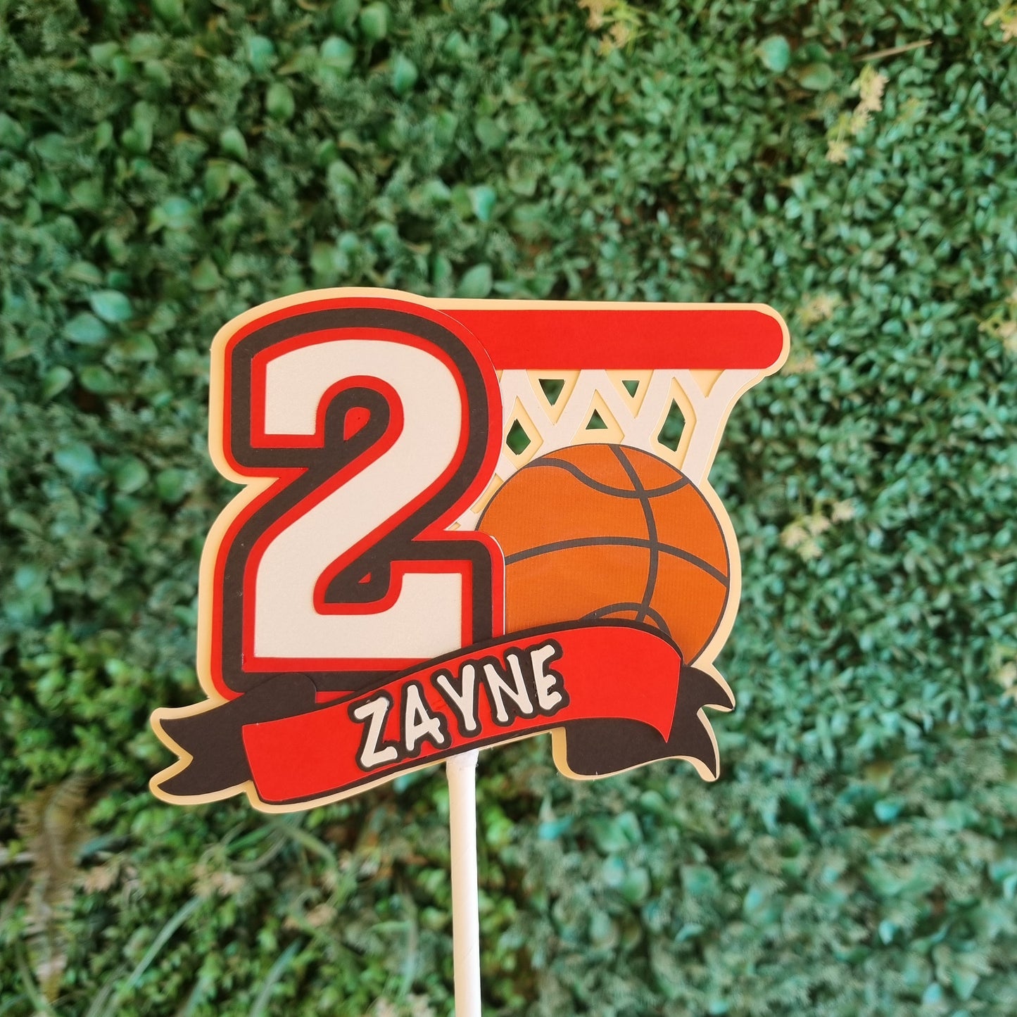 Basketball-themed decorative pick with number 2 and 'Zayne' text on a grass background