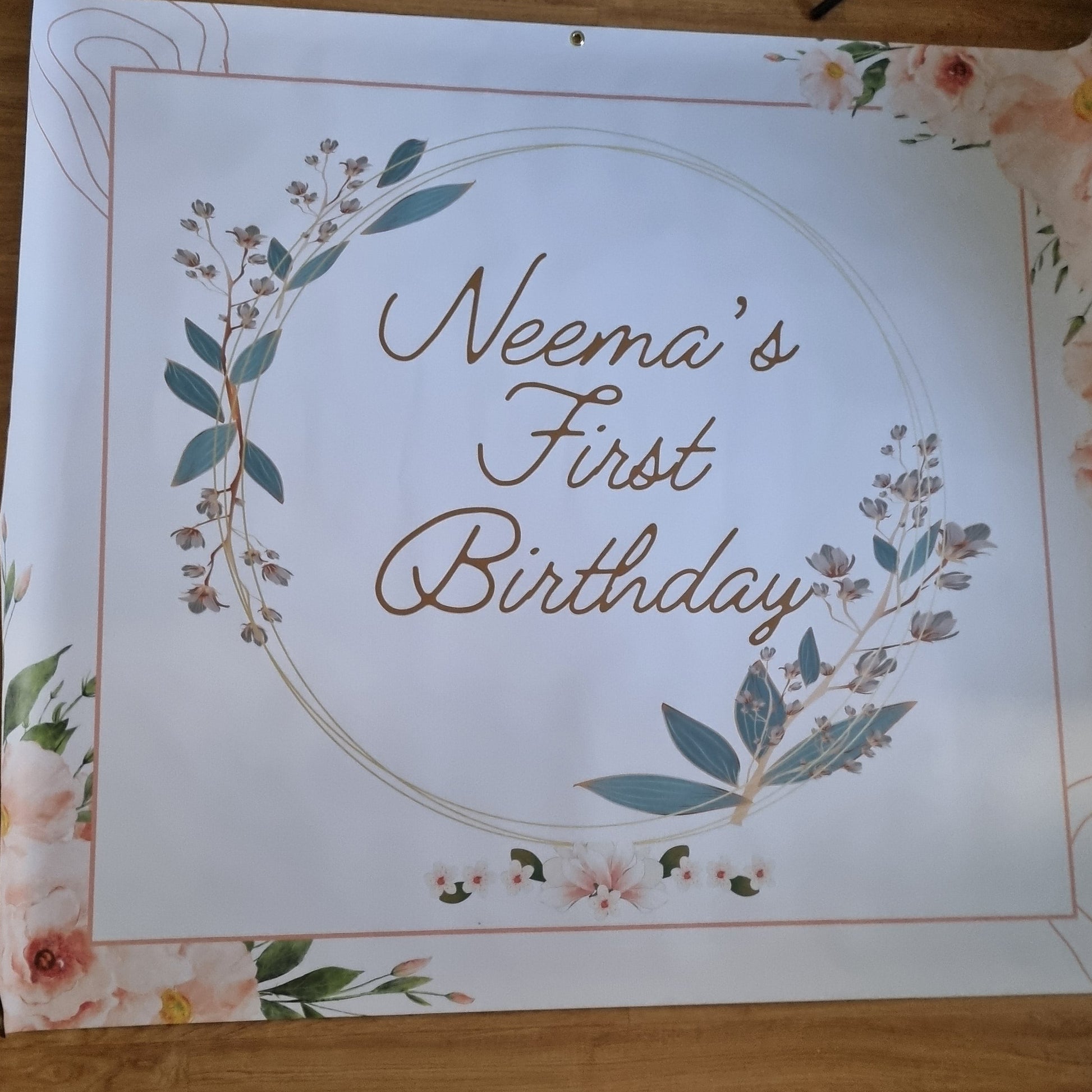 Decorative paper with floral design and text on a wooden floor