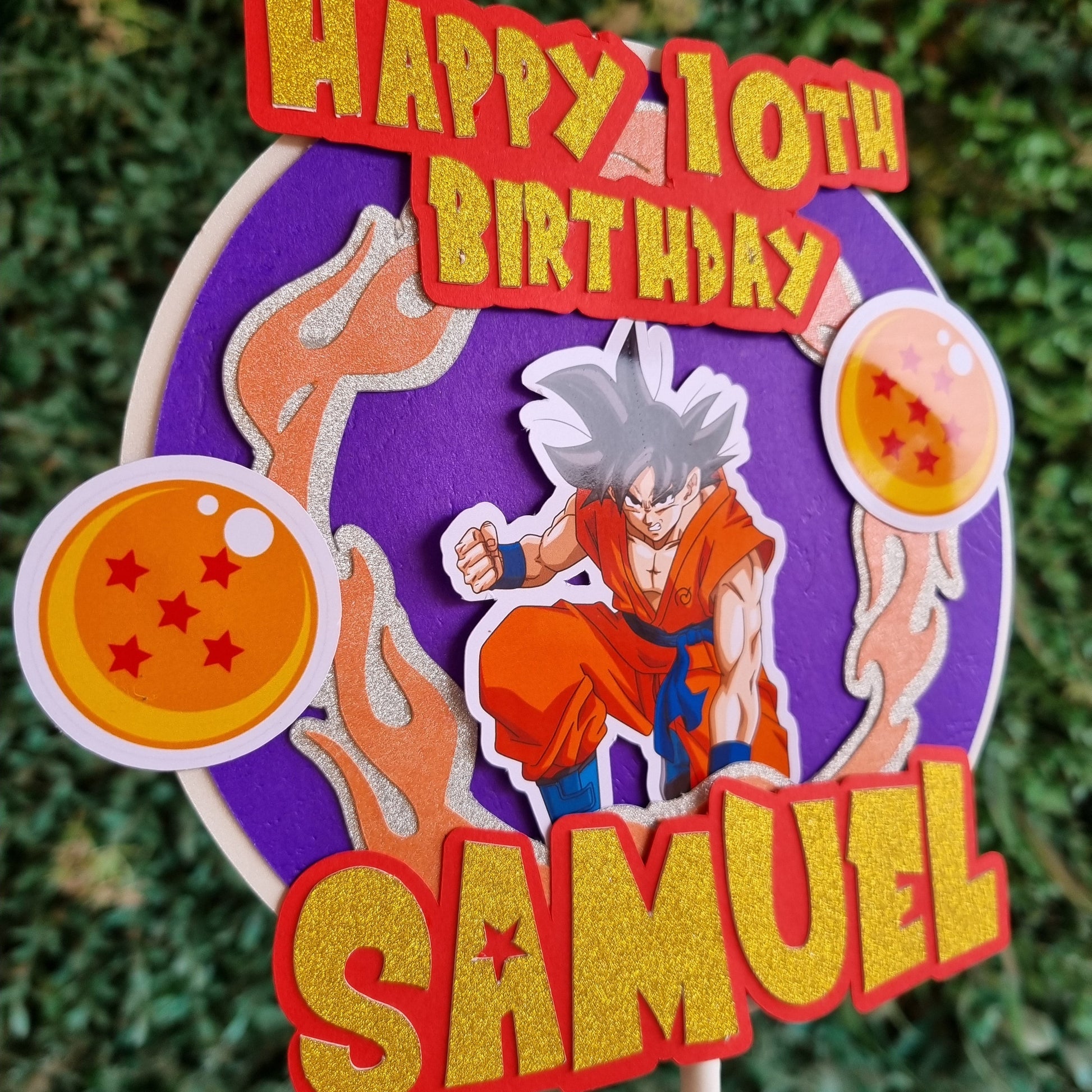 Personalized birthday cake topper with character design and text on a green grass background