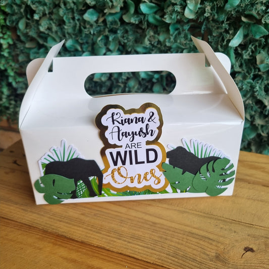 Carton of eggs with 'Wild Oves' branding on a wooden surface and green leafy background
