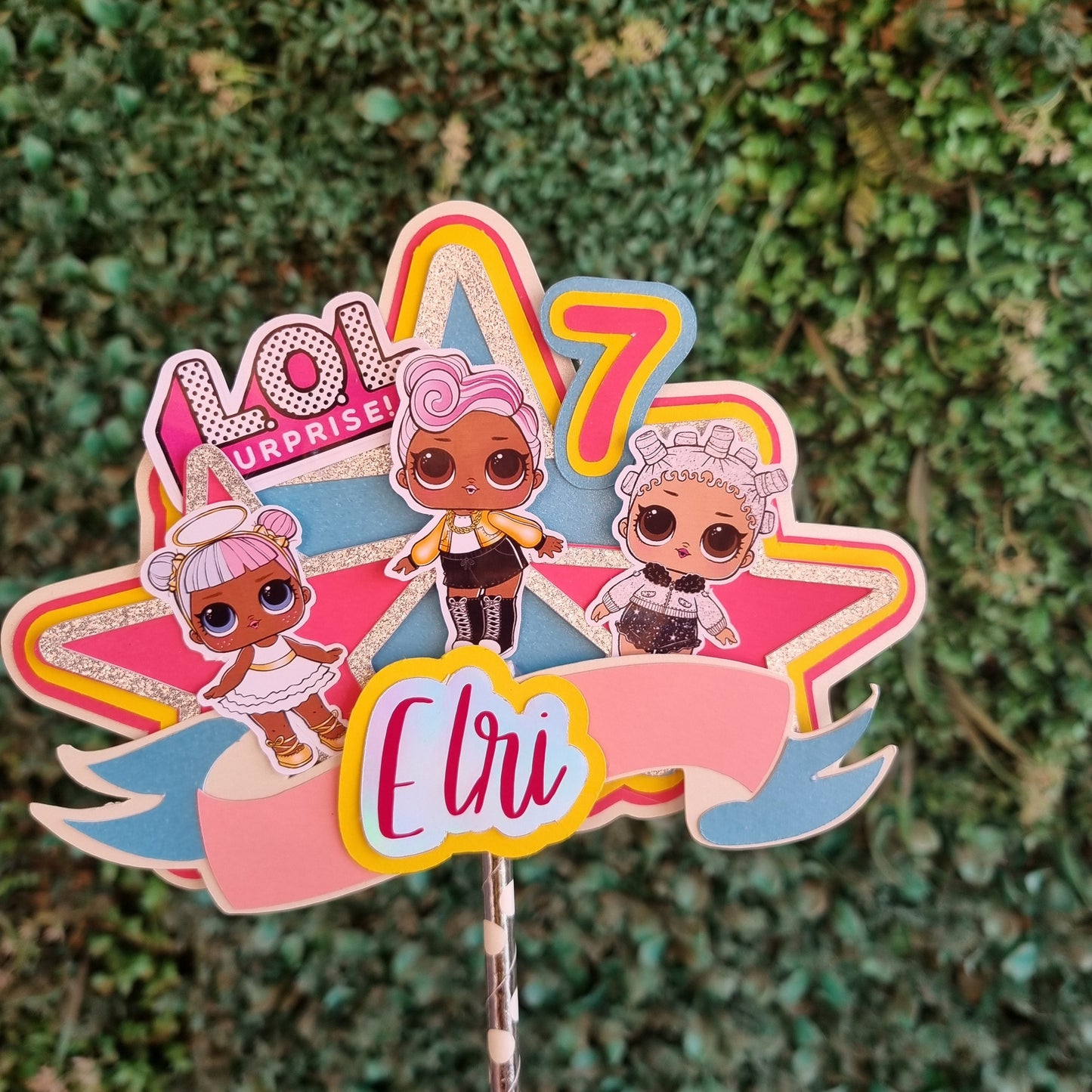 Colorful hair clip with decorative elements on a green textured background