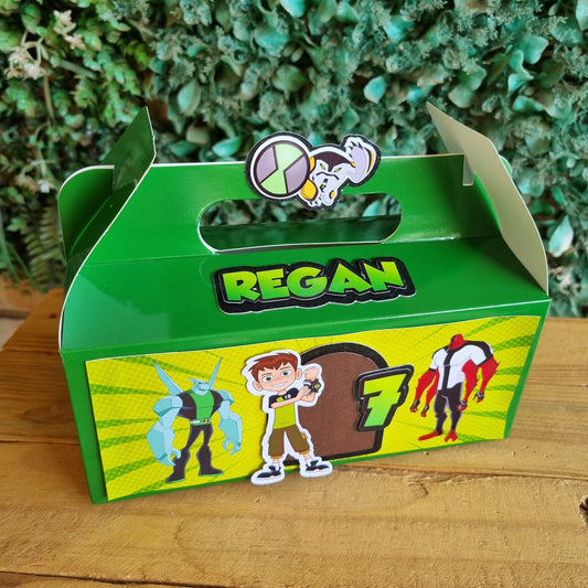 Green and yellow toy box with cartoon characters on a wooden surface and green grass background