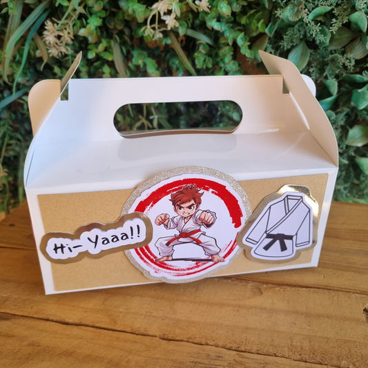 Cardboard box with stickers on a wooden surface and green plants in the background