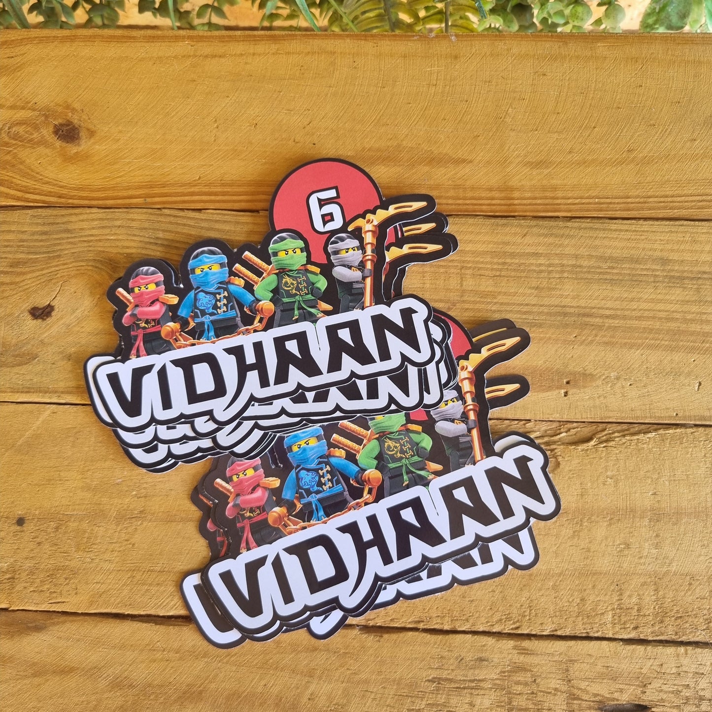 Sticker with 'Vidhan' design on a wooden surface