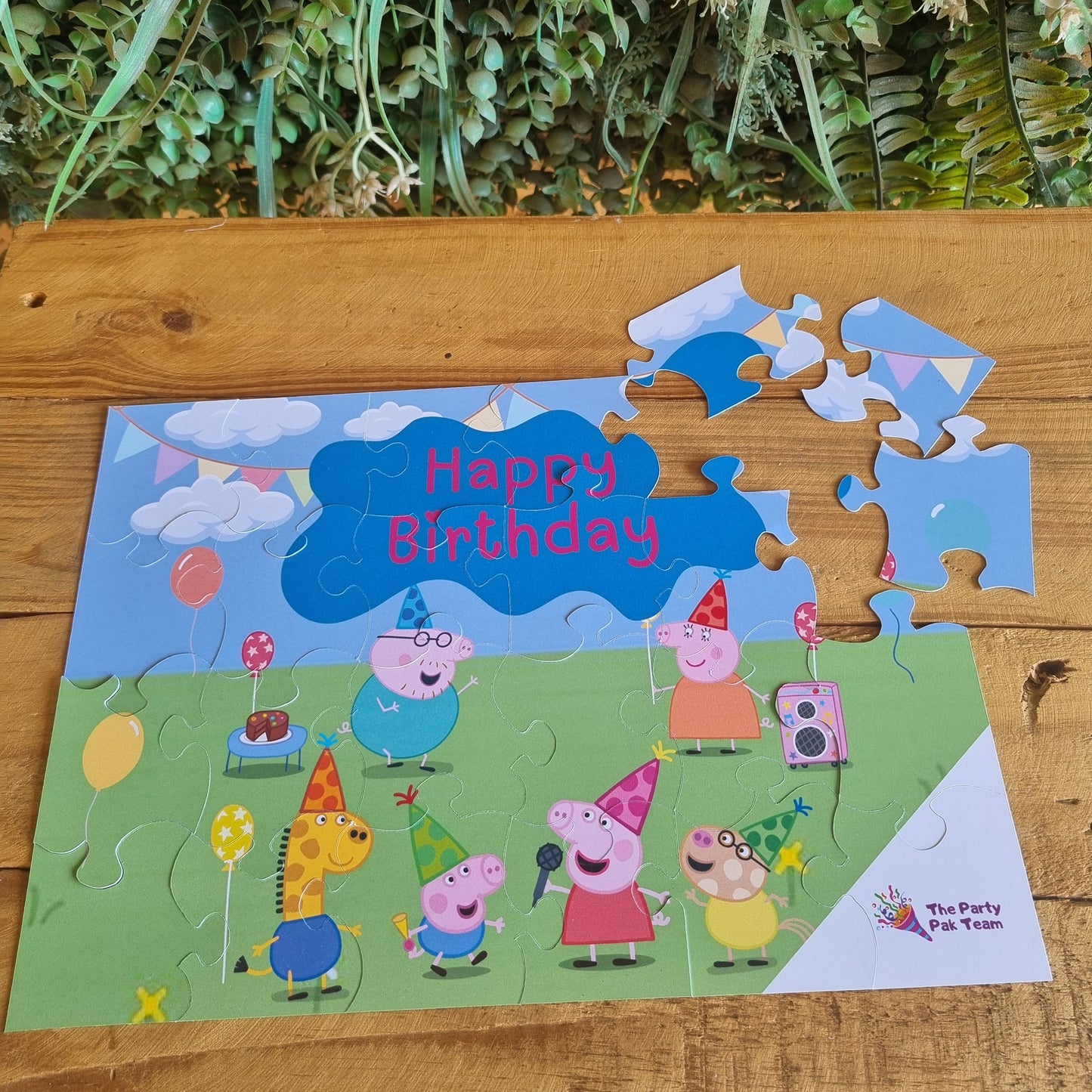 Children's birthday card with Peppa Pig design on a wooden surface