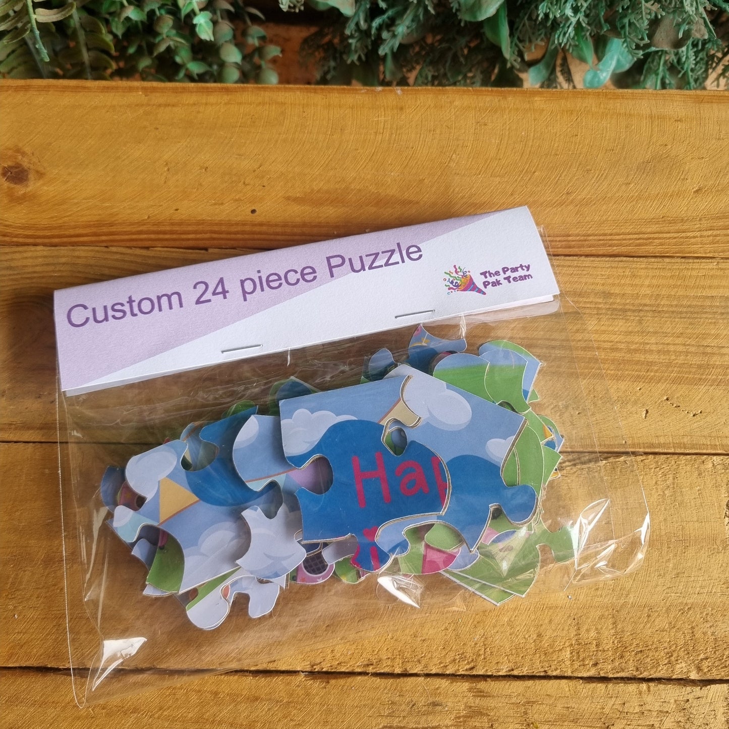 Custom 24 piece puzzle with pieces in a clear bag on a wooden surface
