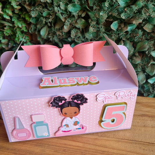 Pink hair bow with packaging featuring cartoon characters on a wooden surface and green foliage background