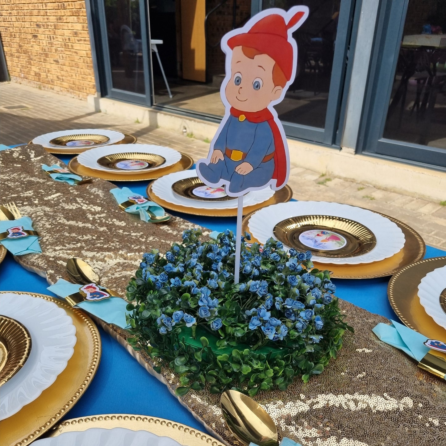 Decorative plates with cartoon character and floral arrangement on a textured surface