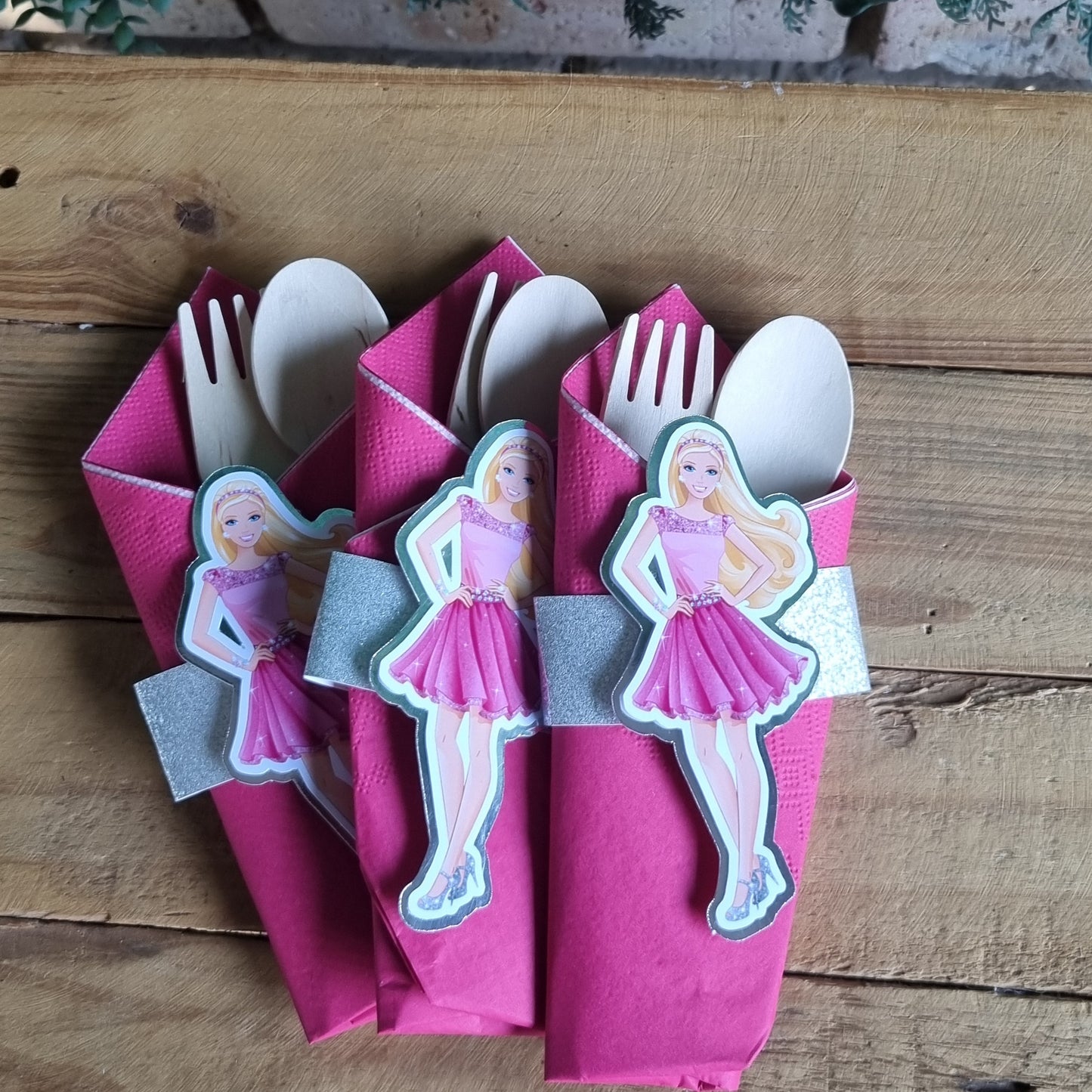 Set of decorative paper plates with cartoon character design on a wooden surface