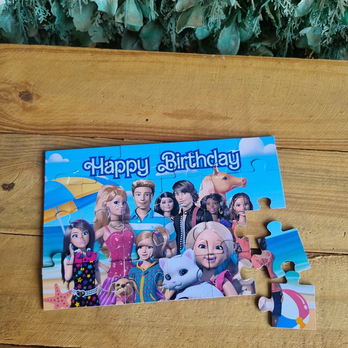 Children's birthday puzzle with cartoon characters on a wooden surface