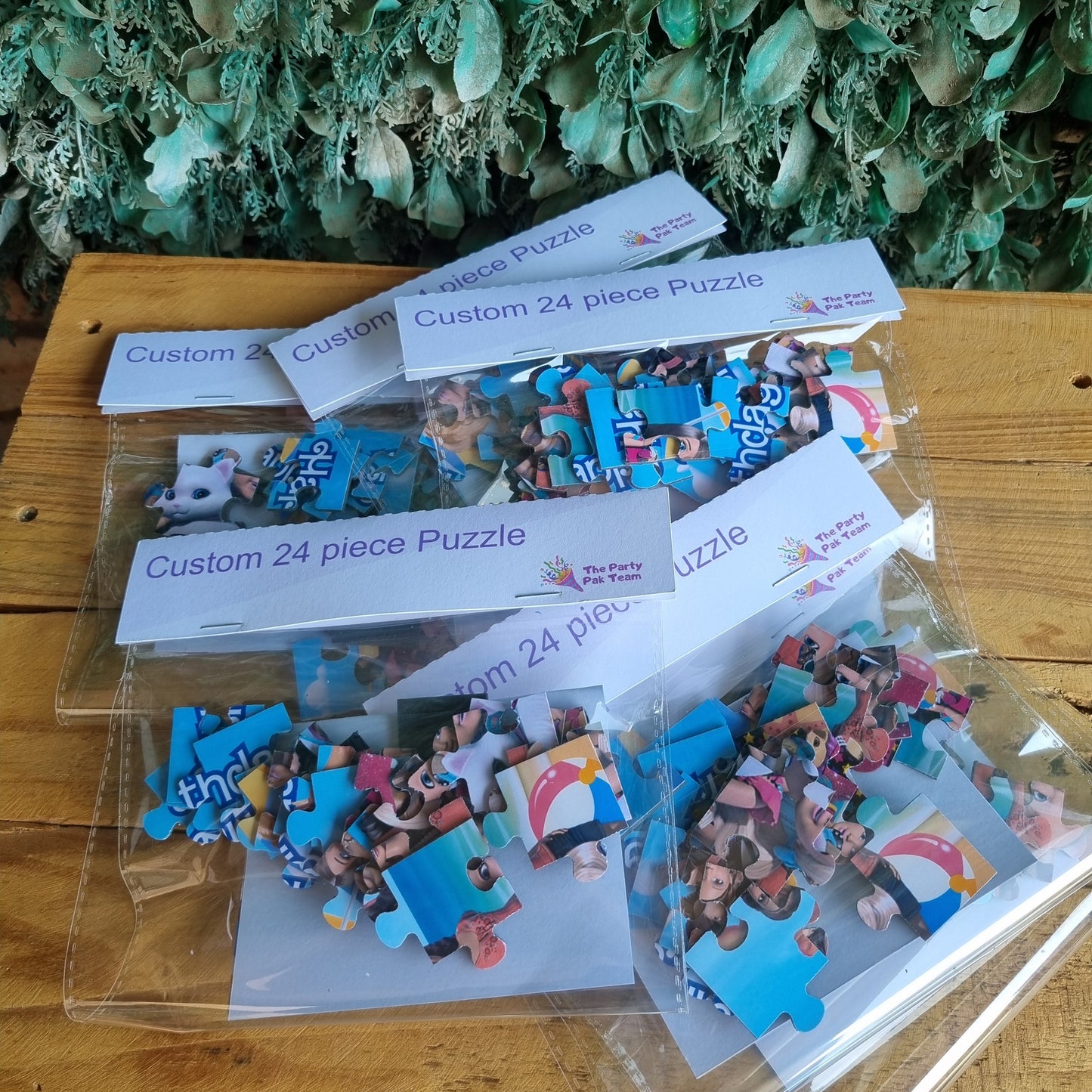 Jigsaw puzzle pieces on a wooden board with packaging and instructions.