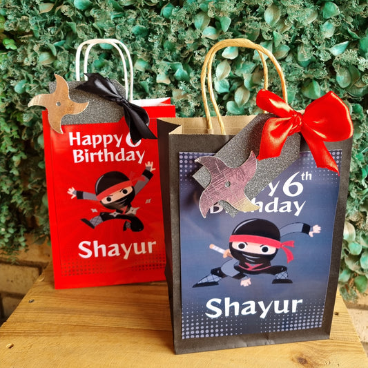 Two birthday cards with decorative ribbons on a textured green surface
