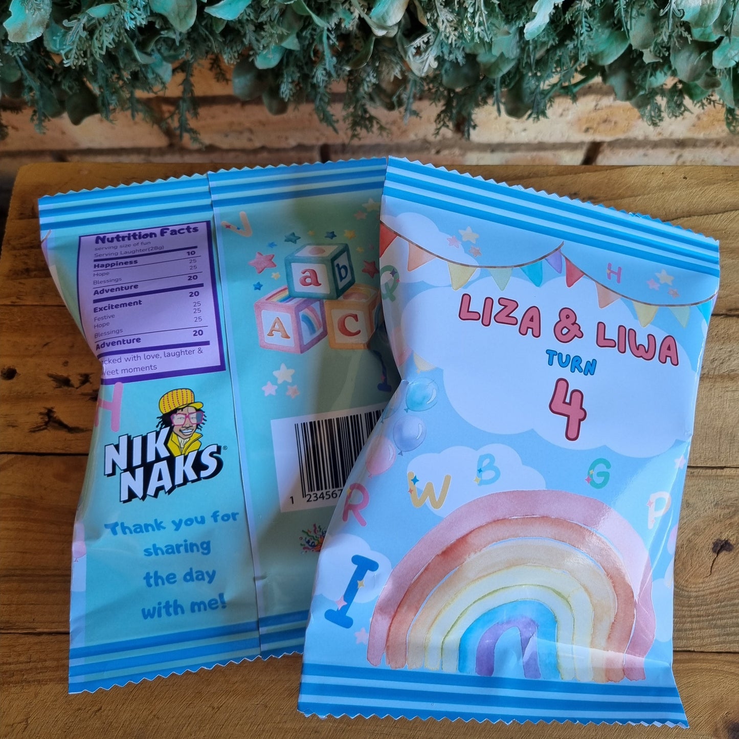 Children's party favor bags with colorful designs on a wooden surface.