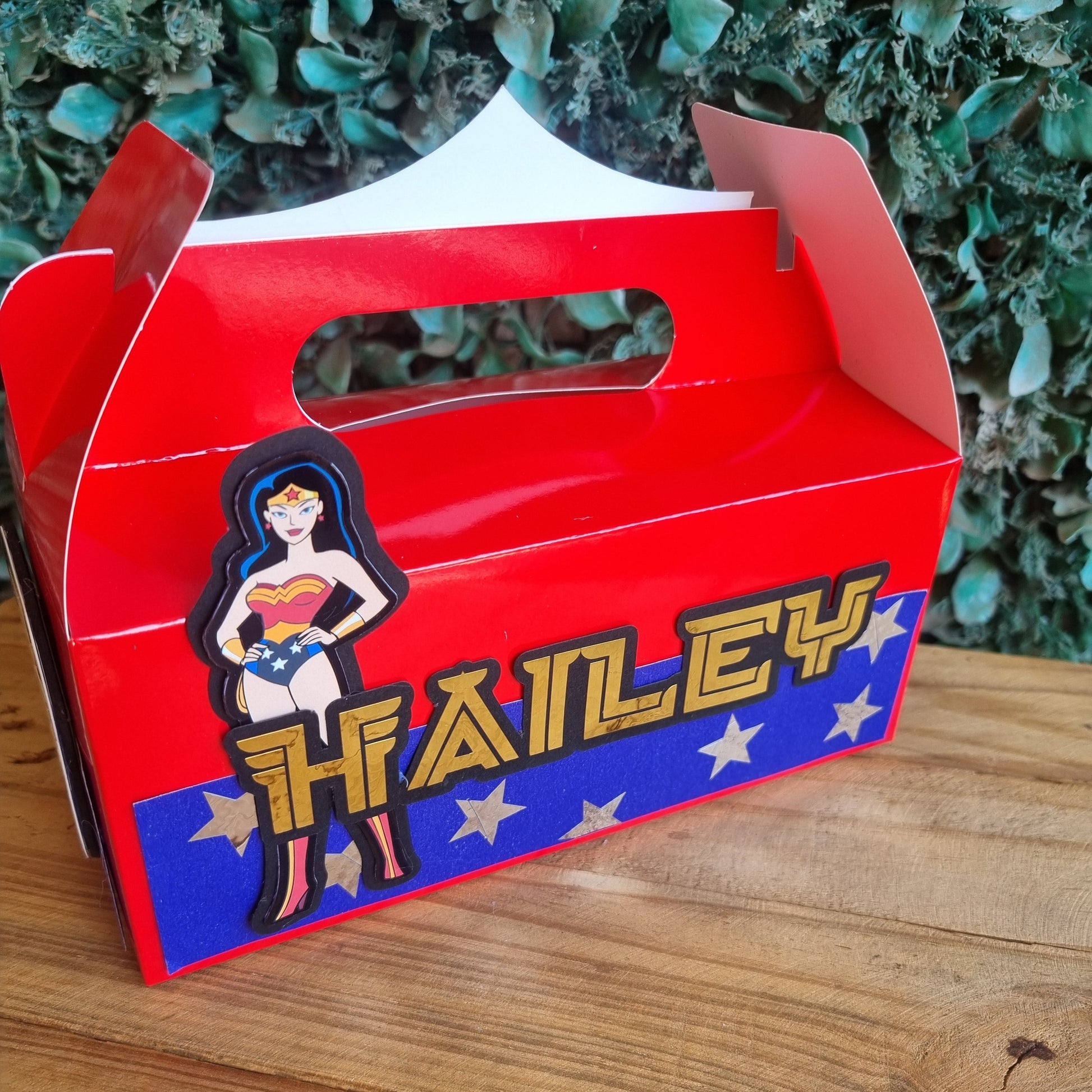 Red and blue box with 'The Family' branding on a wooden surface.