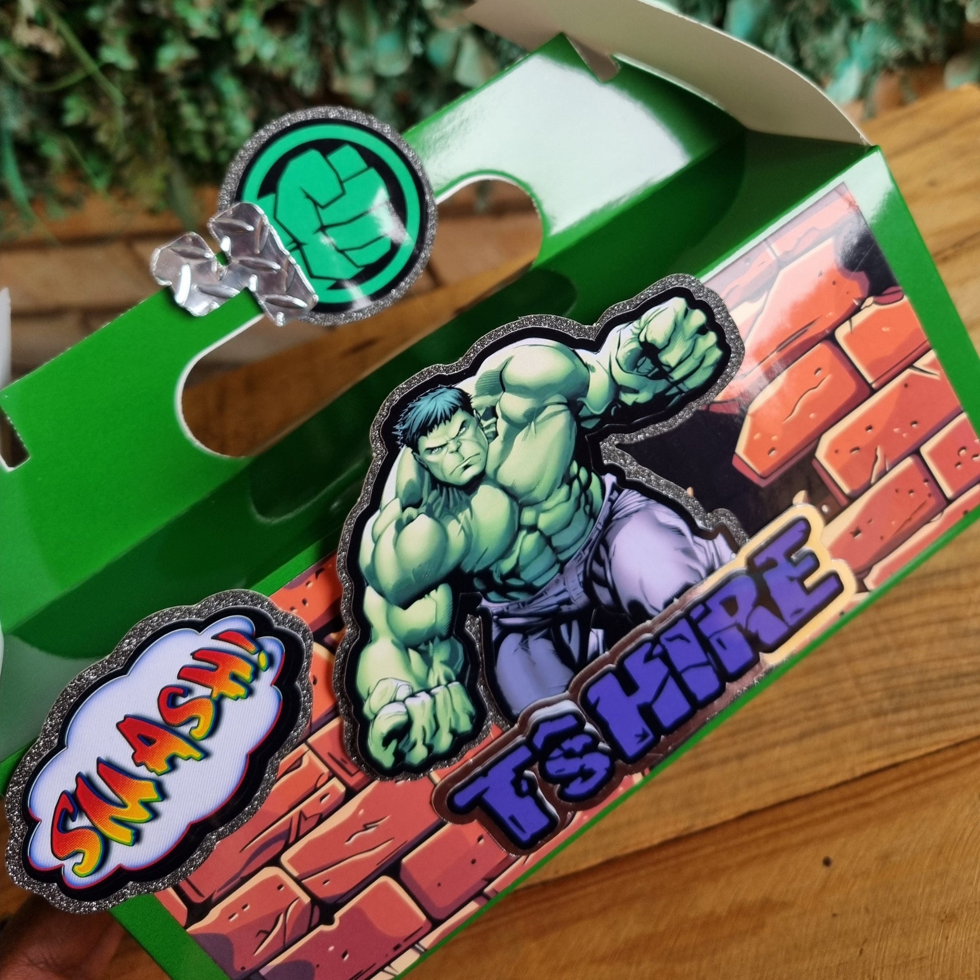 Three superhero-themed pins on a green box with a brick wall design.