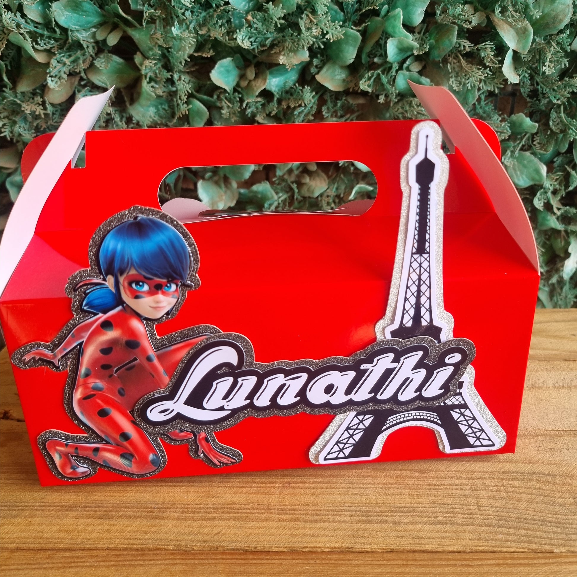 Red box with 'Lunatic' branding featuring a cartoon character against a wooden and green leafy background