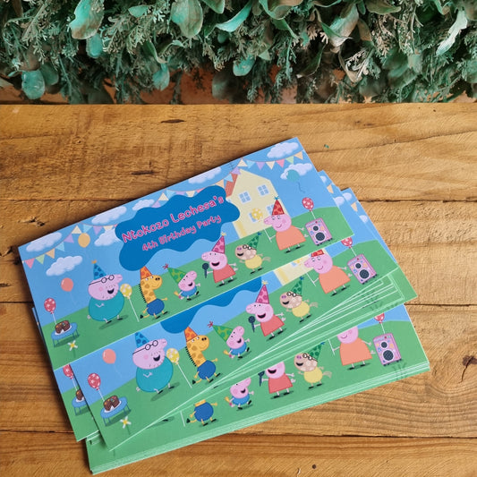 Two children's activity books with colorful illustrations on a wooden surface next to greenery.