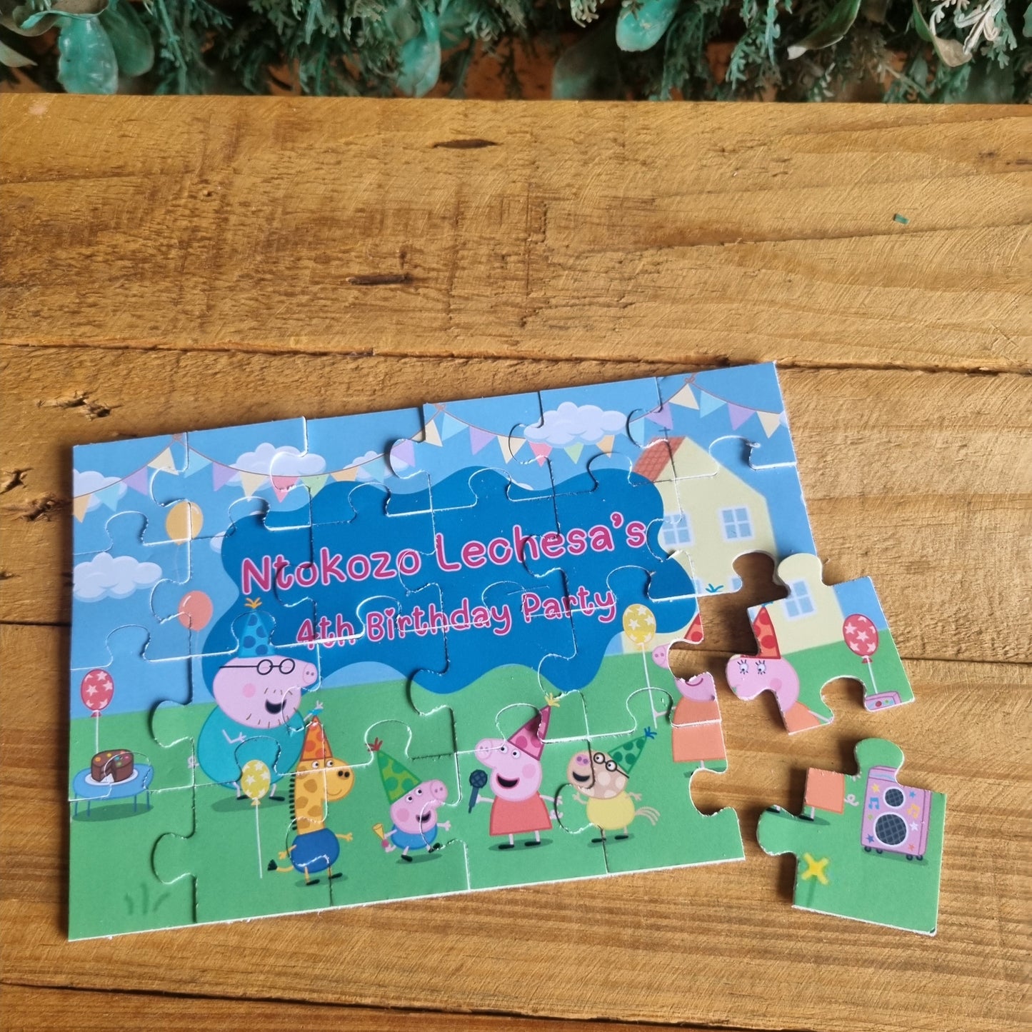 Children's puzzle with a birthday theme on a wooden surface