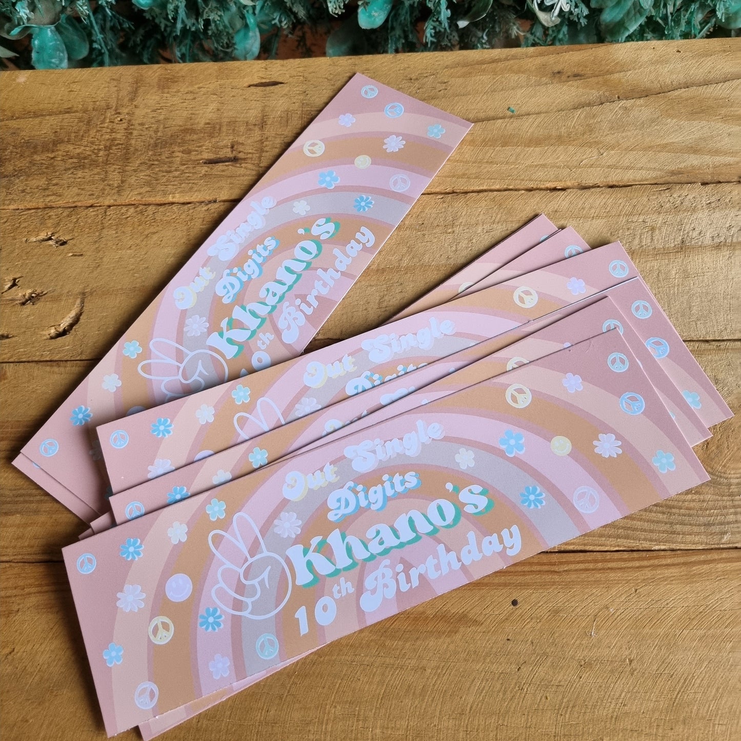 Pink birthday cards with decorative elements on a wooden surface