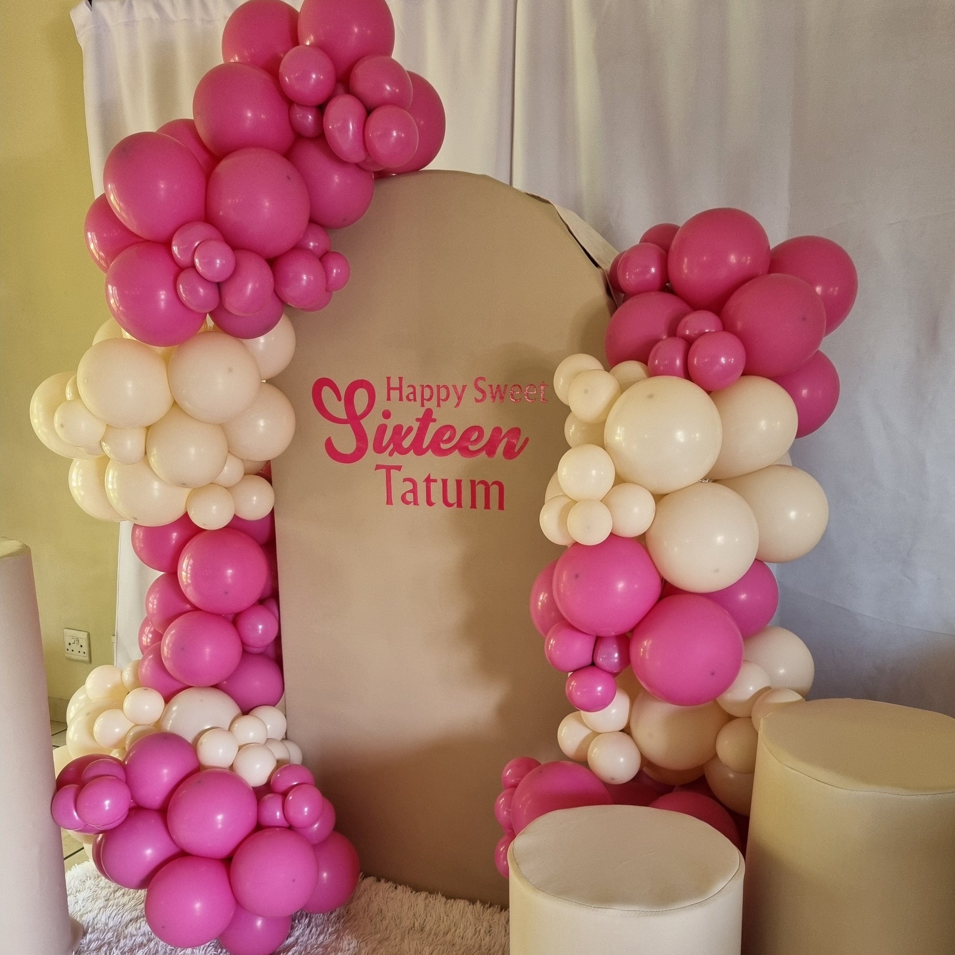 Decorative letter 'A' made of pink and white balloons with a birthday message on a plain background.