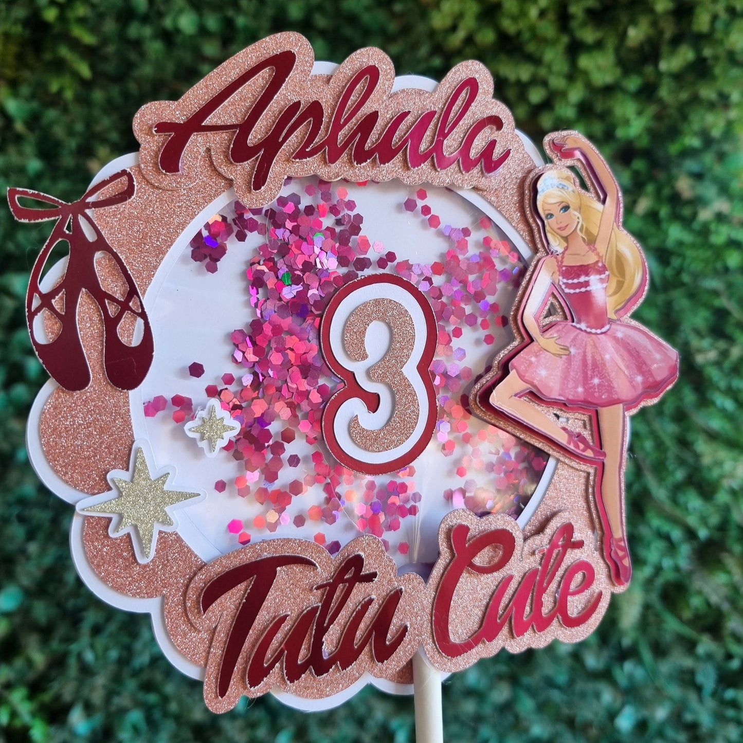 Decorative item with pink and brown colors on a green textured background