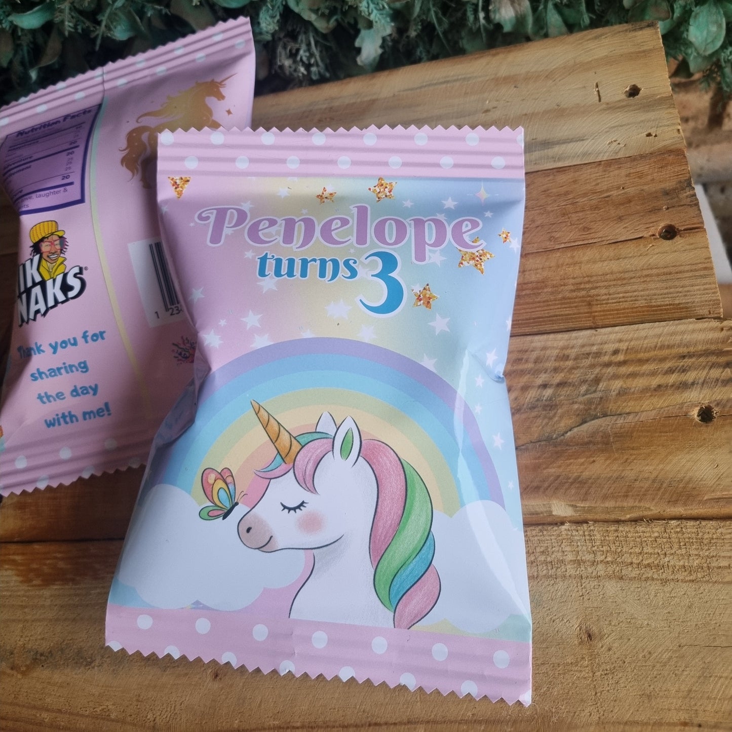 Packaged snacks with a unicorn design on a wooden surface