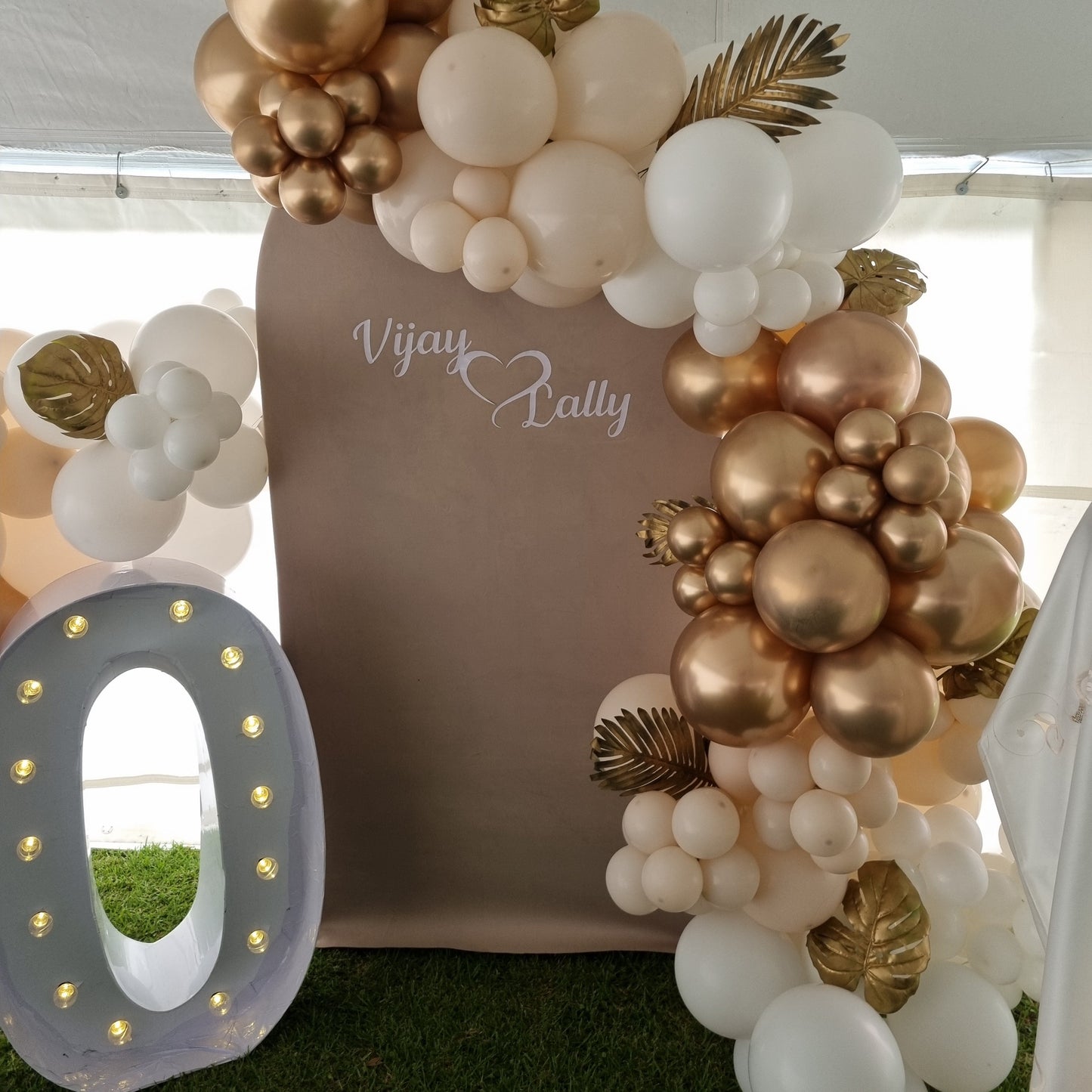 Decorative arch made of balloons and flowers with 'Vivian Party' branding.