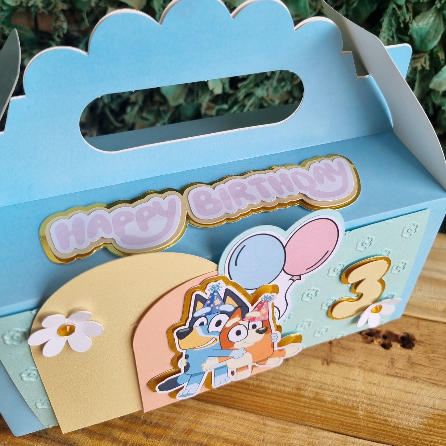 Decorative birthday card with cartoon characters on a wooden surface