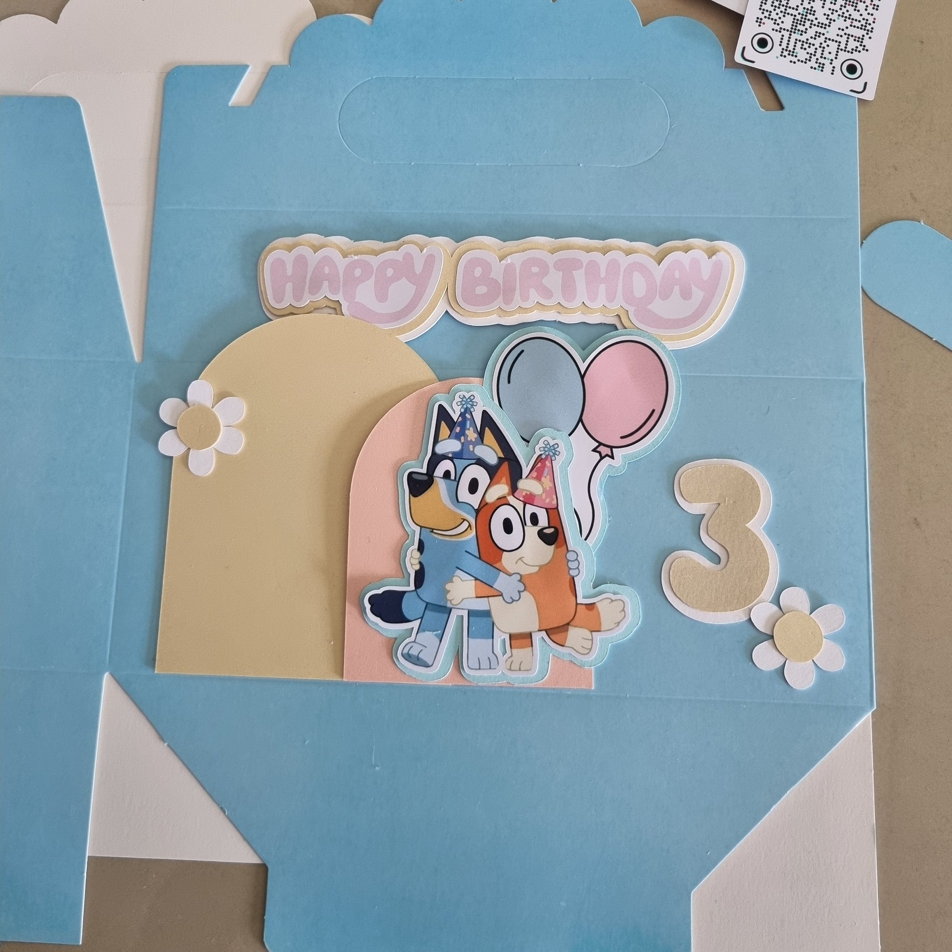 Children's birthday card with cartoon character and number 3 on a blue background