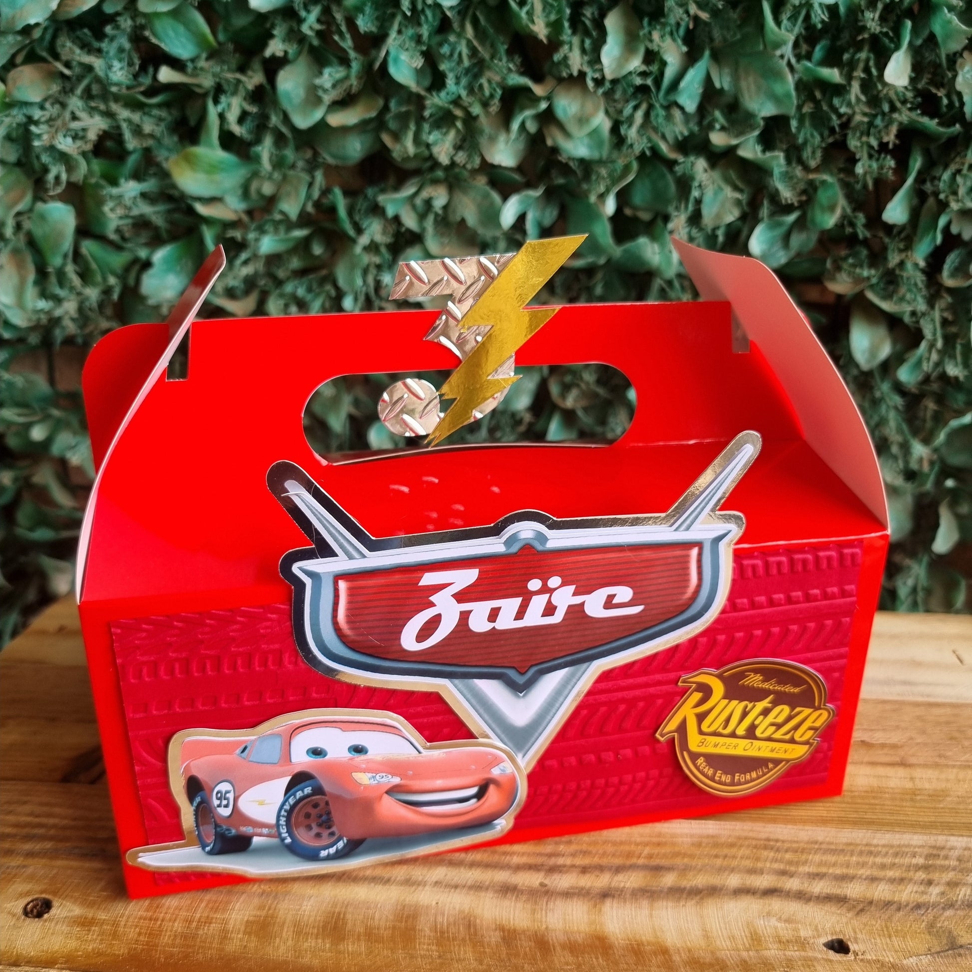 Red metal sign with 'Dairy' and 'Rutger's' branding on a wooden surface with greenery in the background.