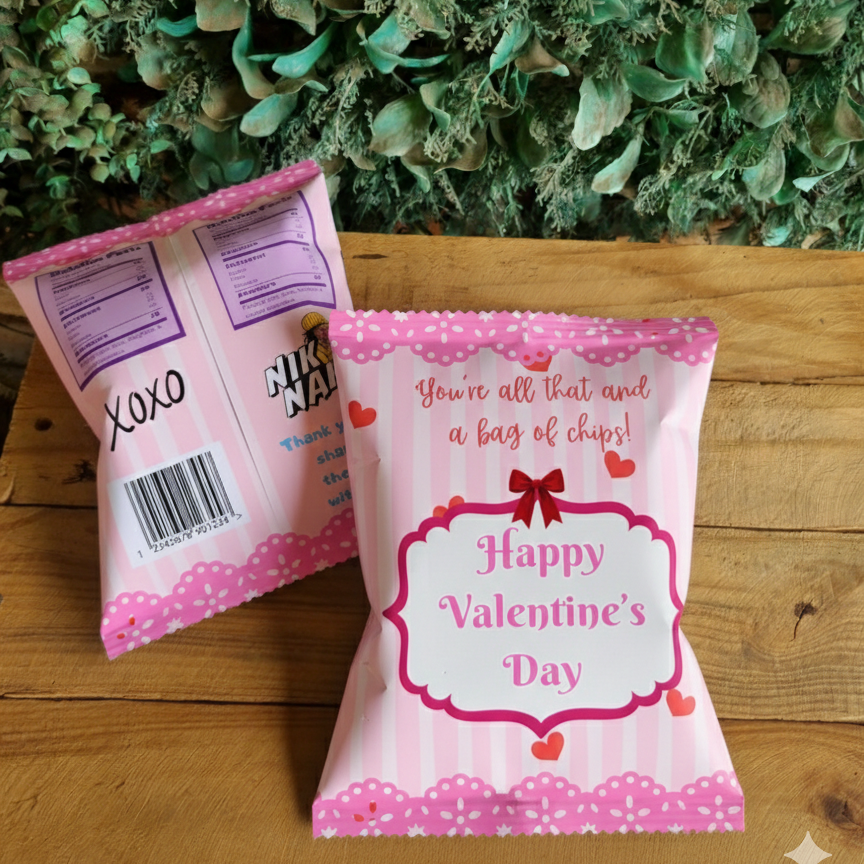 Two pink snack bags with Valentine's Day messages on a wooden surface with green foliage in the background.