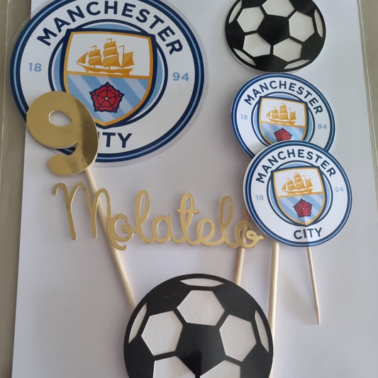 Soccer-themed cupcake toppers with Manchester City logo on a white sheet of paper.