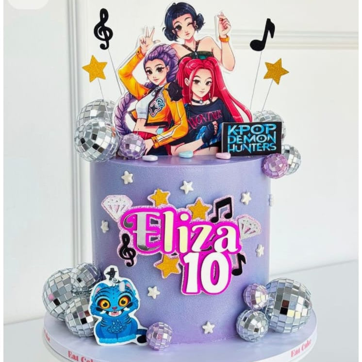 Two-tiered birthday cake with 'Eliza 10' on a white background