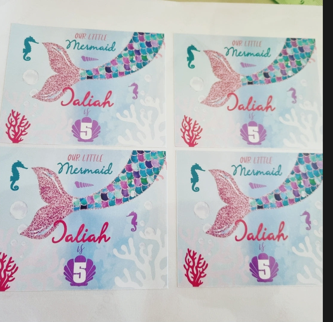 Four stickers with mermaid tails and 'Jalilah Mermaid' text on a light blue background.