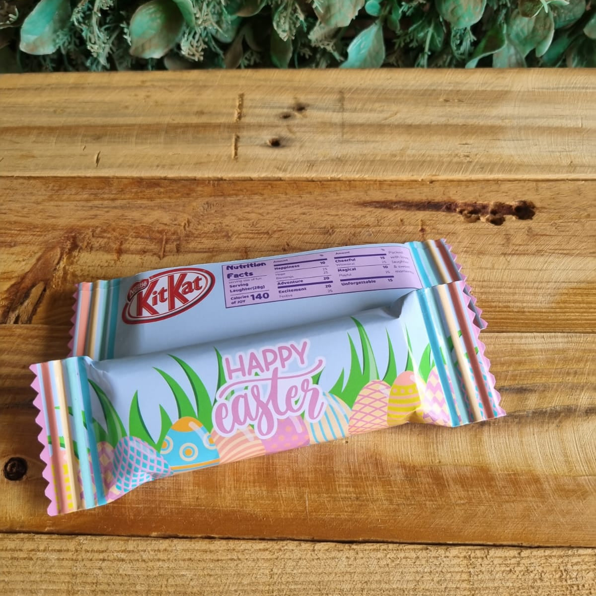 KitKat Easter chocolate bar with colorful packaging on a wooden surface