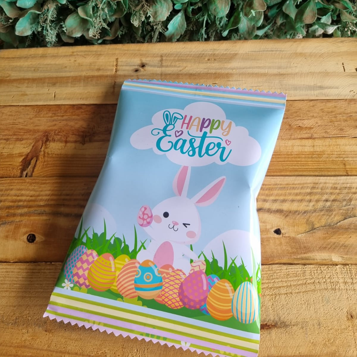 Children's party favor bag with Easter design on a wooden surface